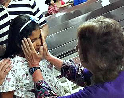 photo of a woman laying hands on a blind girl, who immediately had her sight restored photo of a woman laying hands on a blind girl, who immediately had her sight restored
