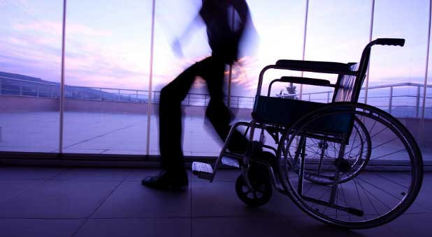 man walling out of wheelchair